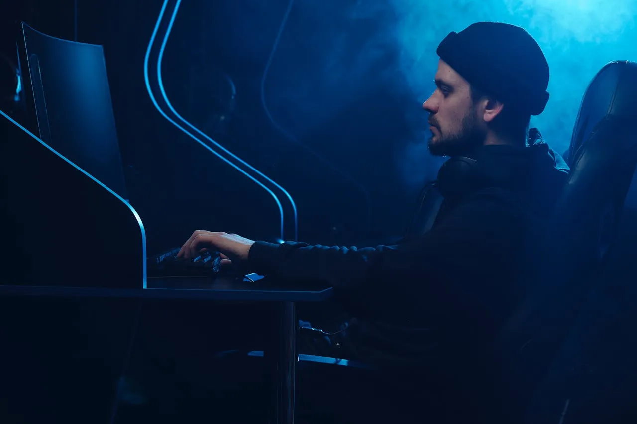 A person with side view sitting in front of desktop