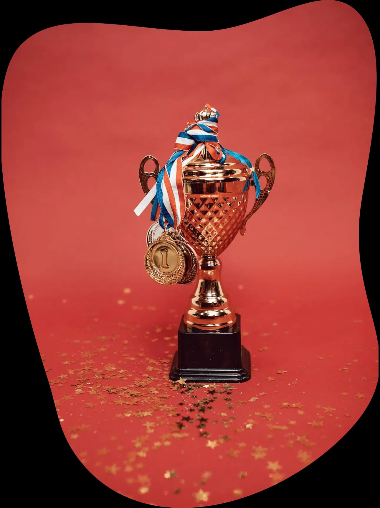 A trophy with medals and a red background