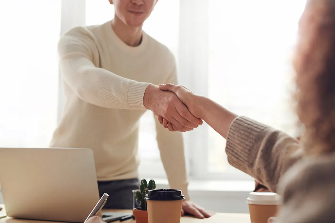 A man shaking hand with a woman